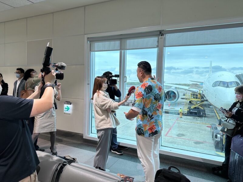 a group of people taking pictures of an airplane