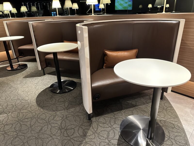 a booth seating with a white table and brown cushion