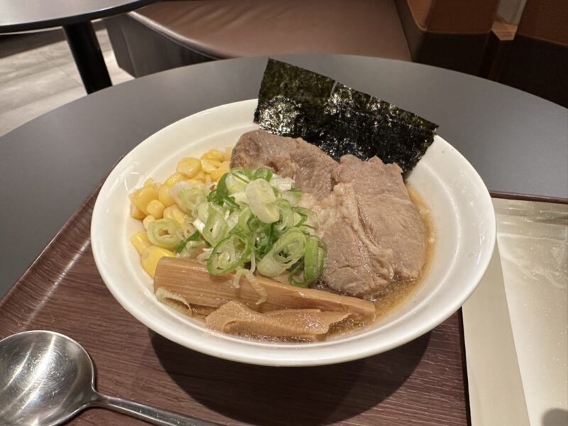 a bowl of soup with meat and corn