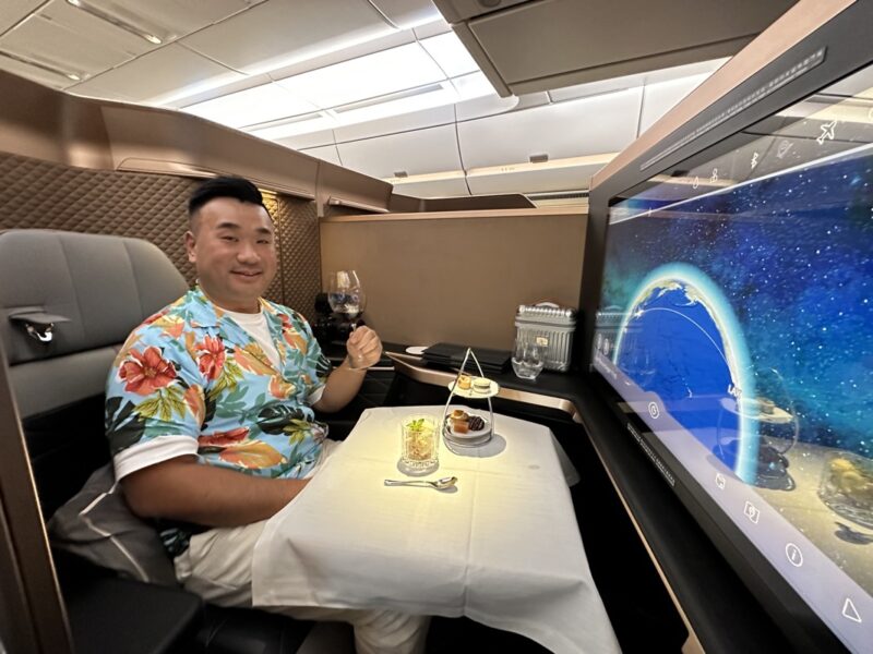 a man sitting in a chair with a television