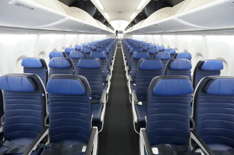 a row of blue seats in an airplane