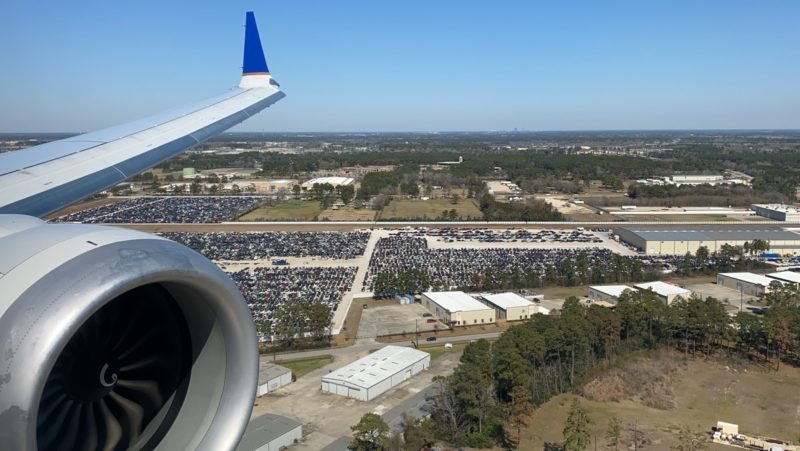 an airplane wing and a parking lot