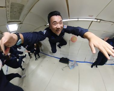 a man in uniform jumping in a room