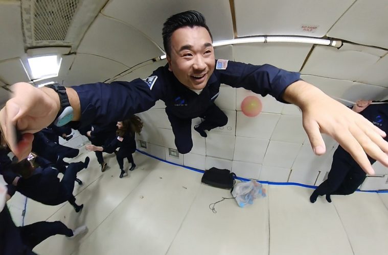 a man in uniform jumping in a room