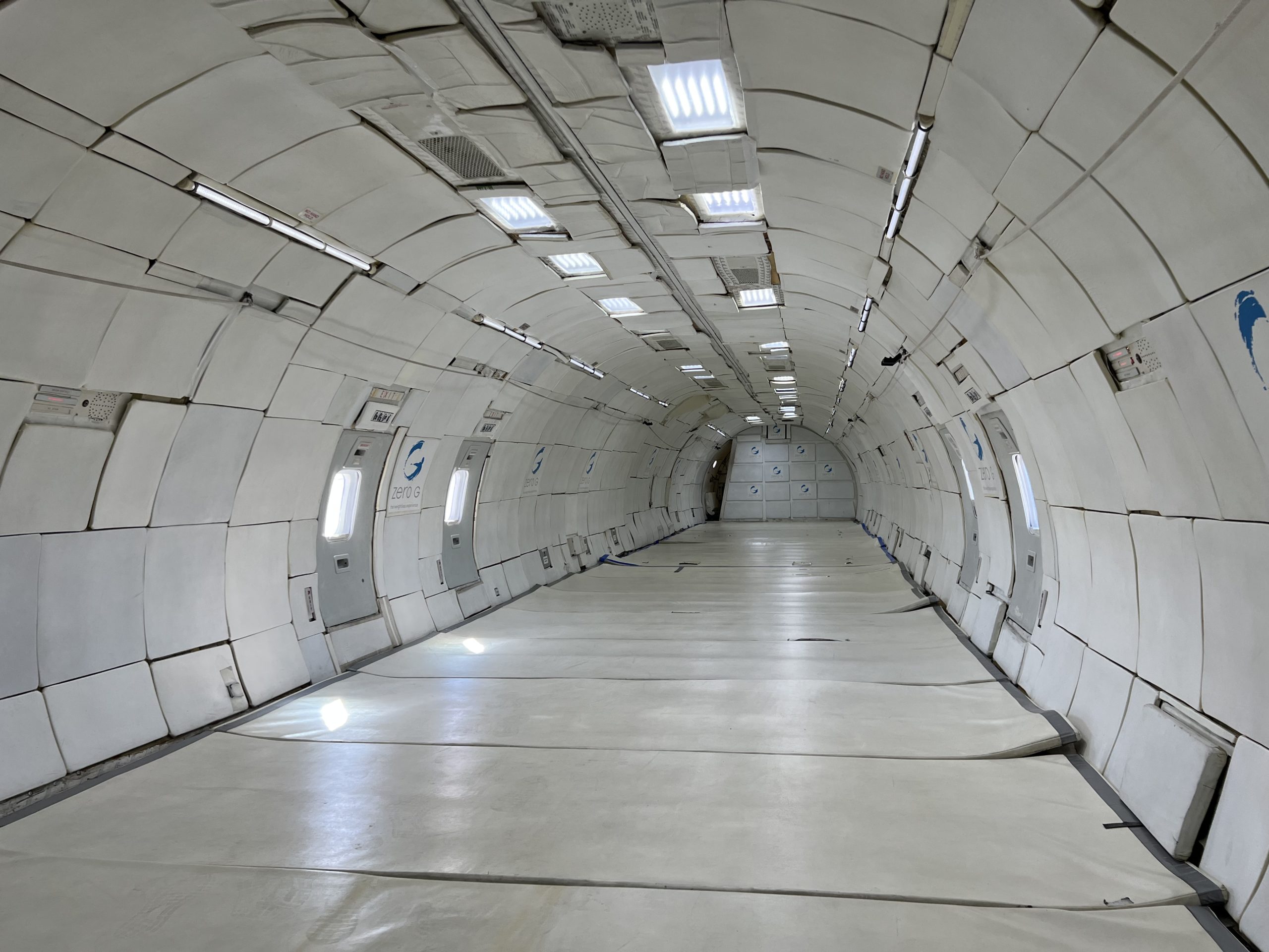 a long white tunnel with lights